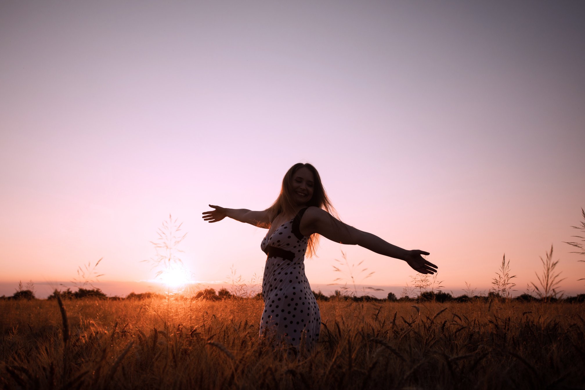 Peaceful Woman Wellcoming the Rising Sun in Field